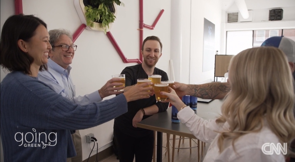 Epic Cleantec employees cheersing with our OneWater Brew on CNN's Going Green series