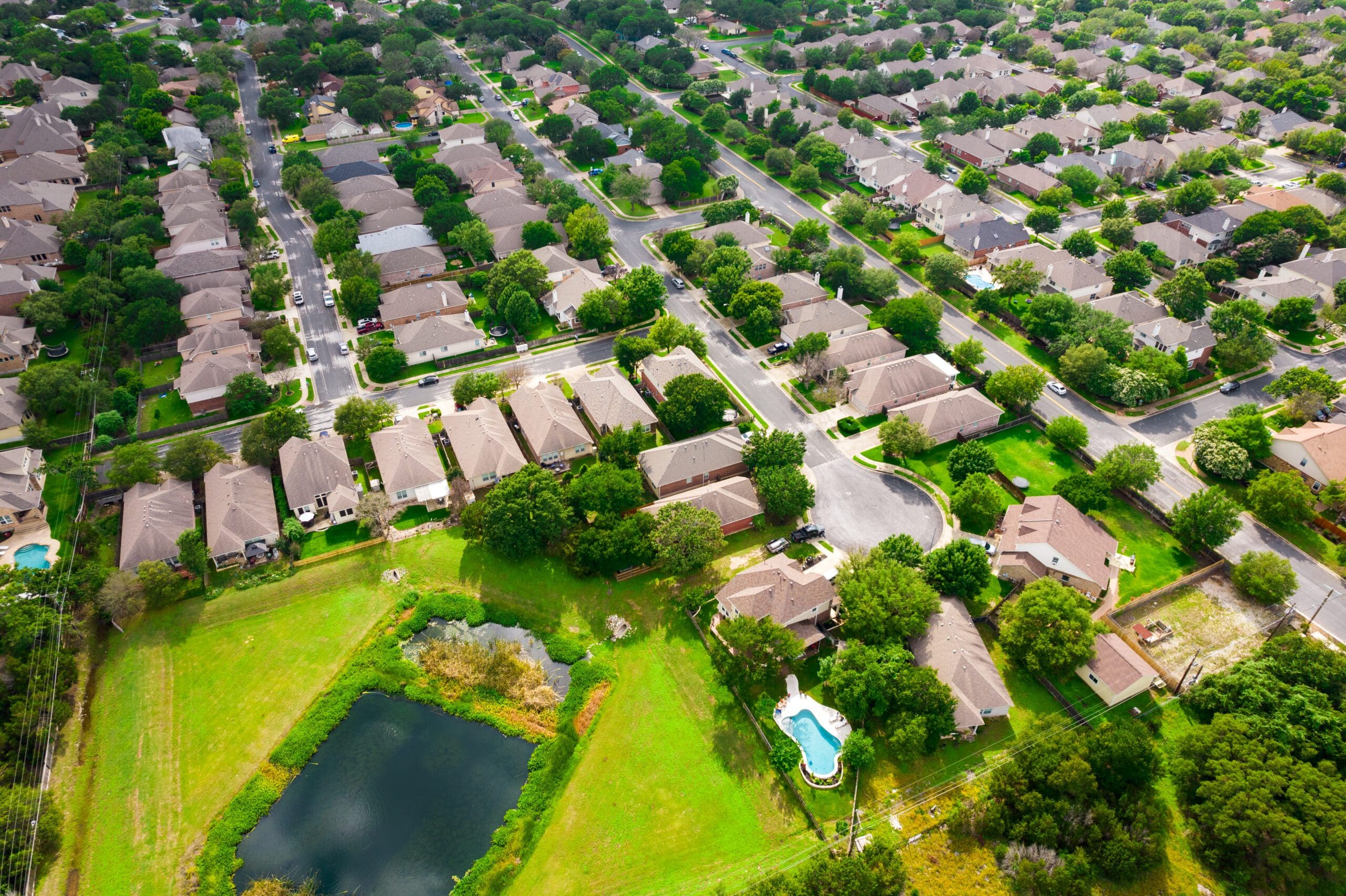 Aerial Drone view above Luxury living gated community Suburb in Austin Texas USA green summer landscape